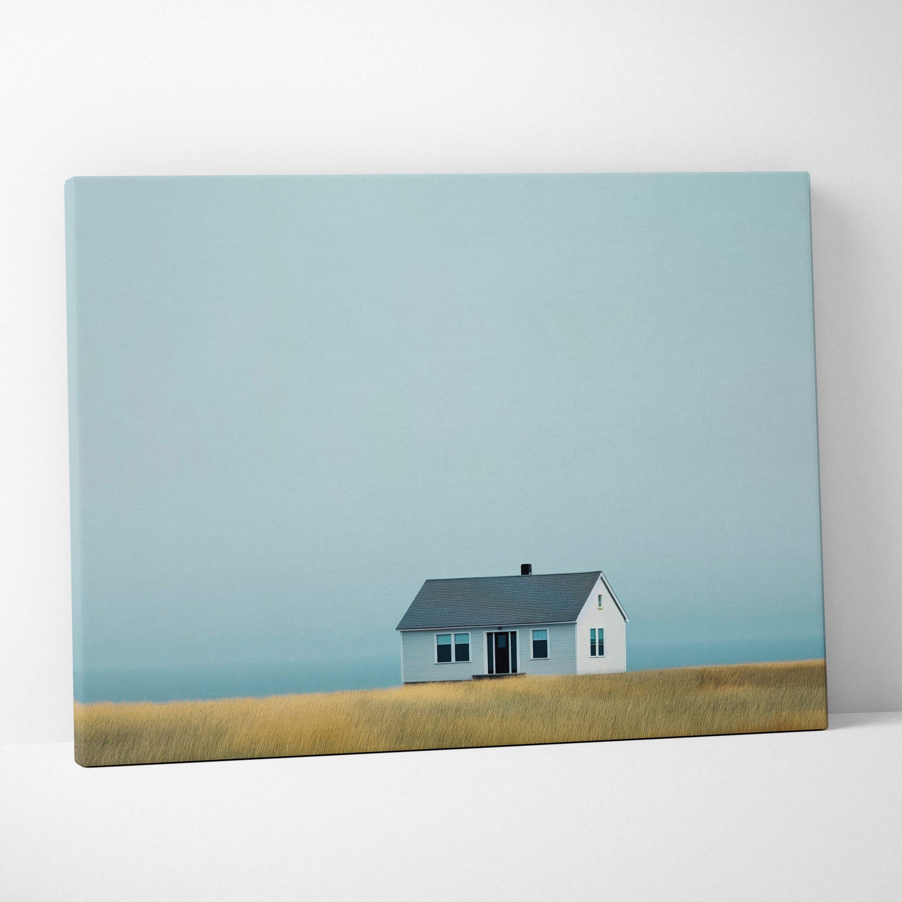 Canvas wall art featuring a solitary house with blue roof in a minimalistic field under a pale blue sky.