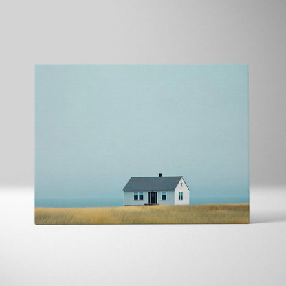 Canvas wall art featuring a minimalist house with a gray roof on a muted grassy plain under a pale blue sky.