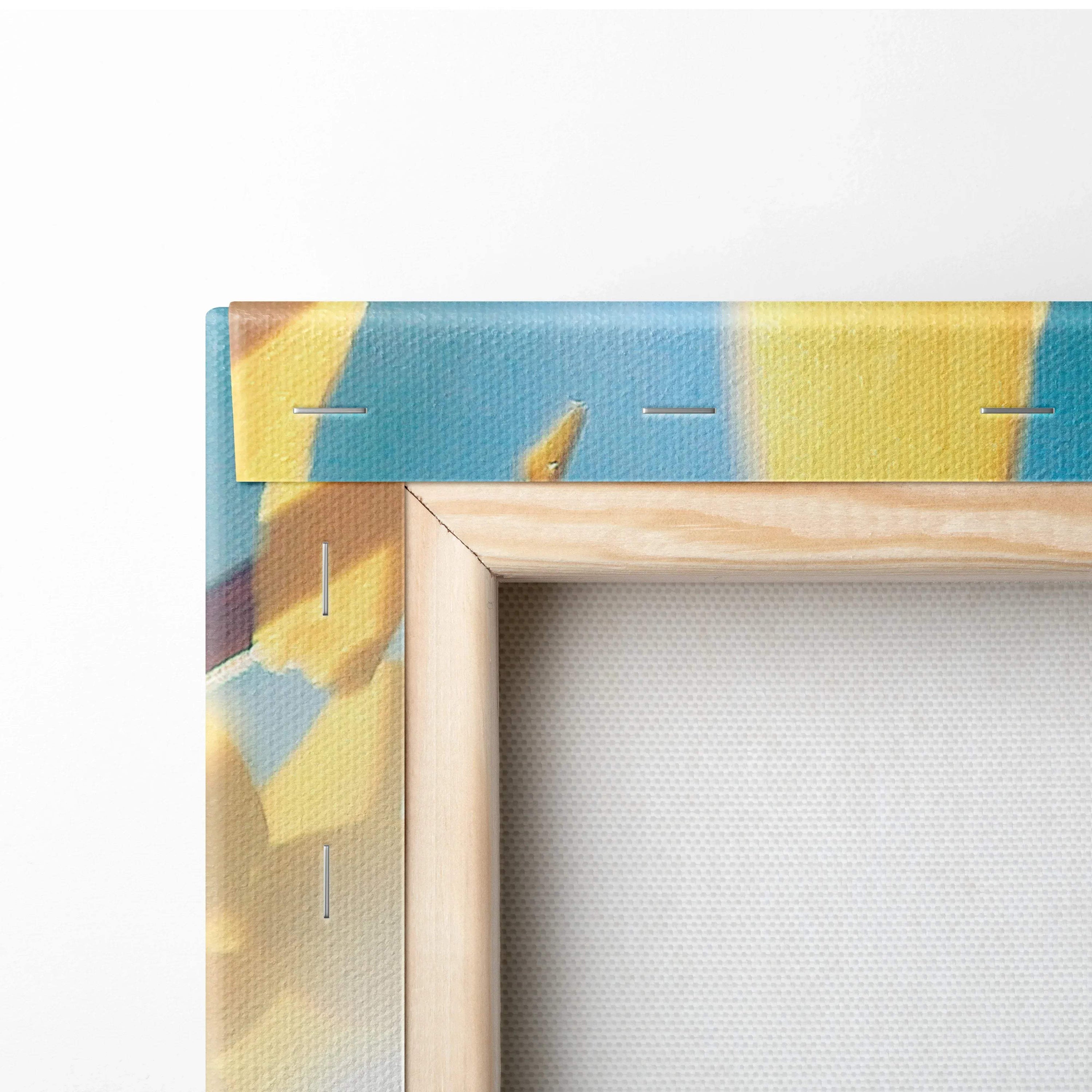 Close-up of canvas edge showing wooden frame and vibrant yellow and blue floral wall art detail on decor canvas.