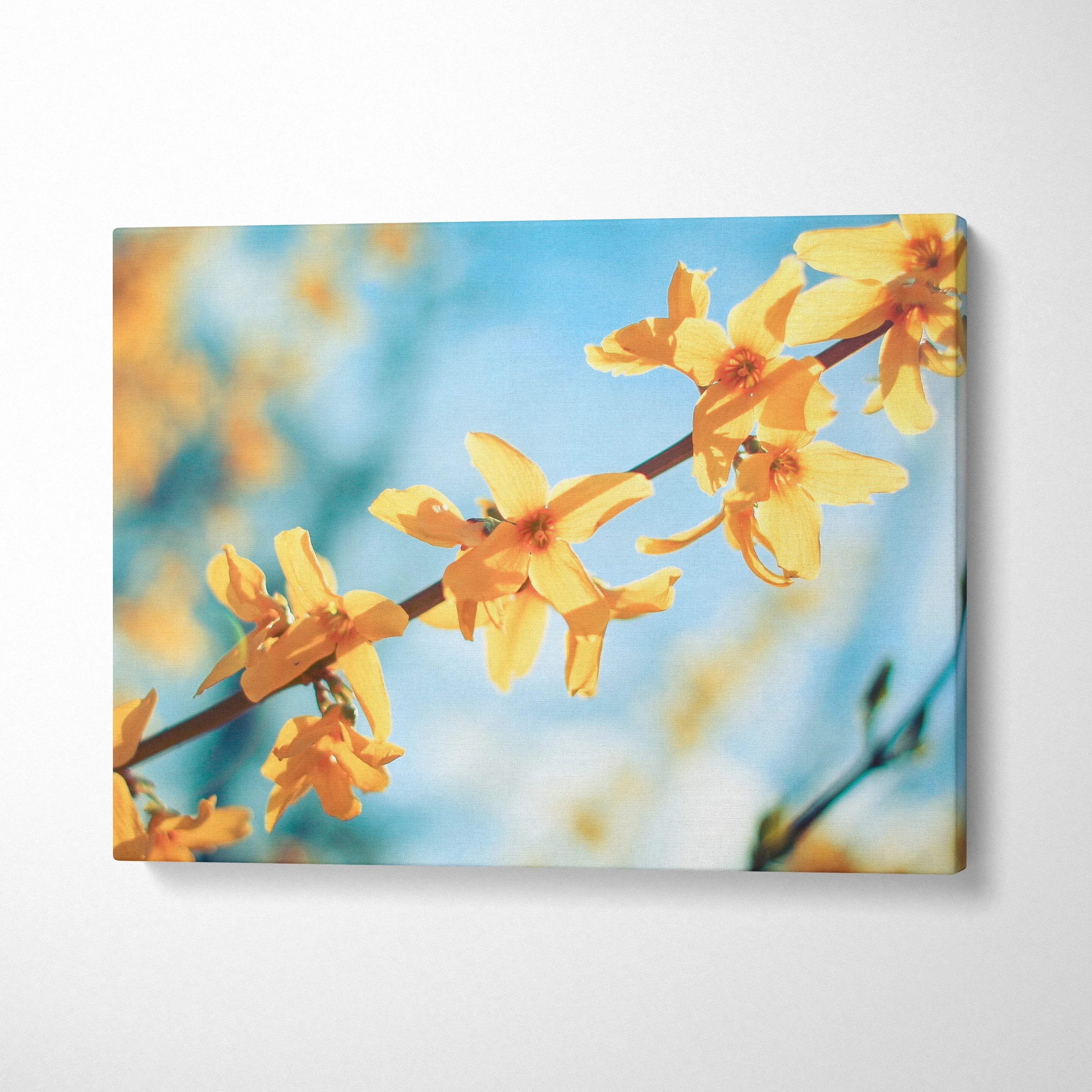Yellow flower branch close-up on blue sky canvas wall art decor with soft focus background.