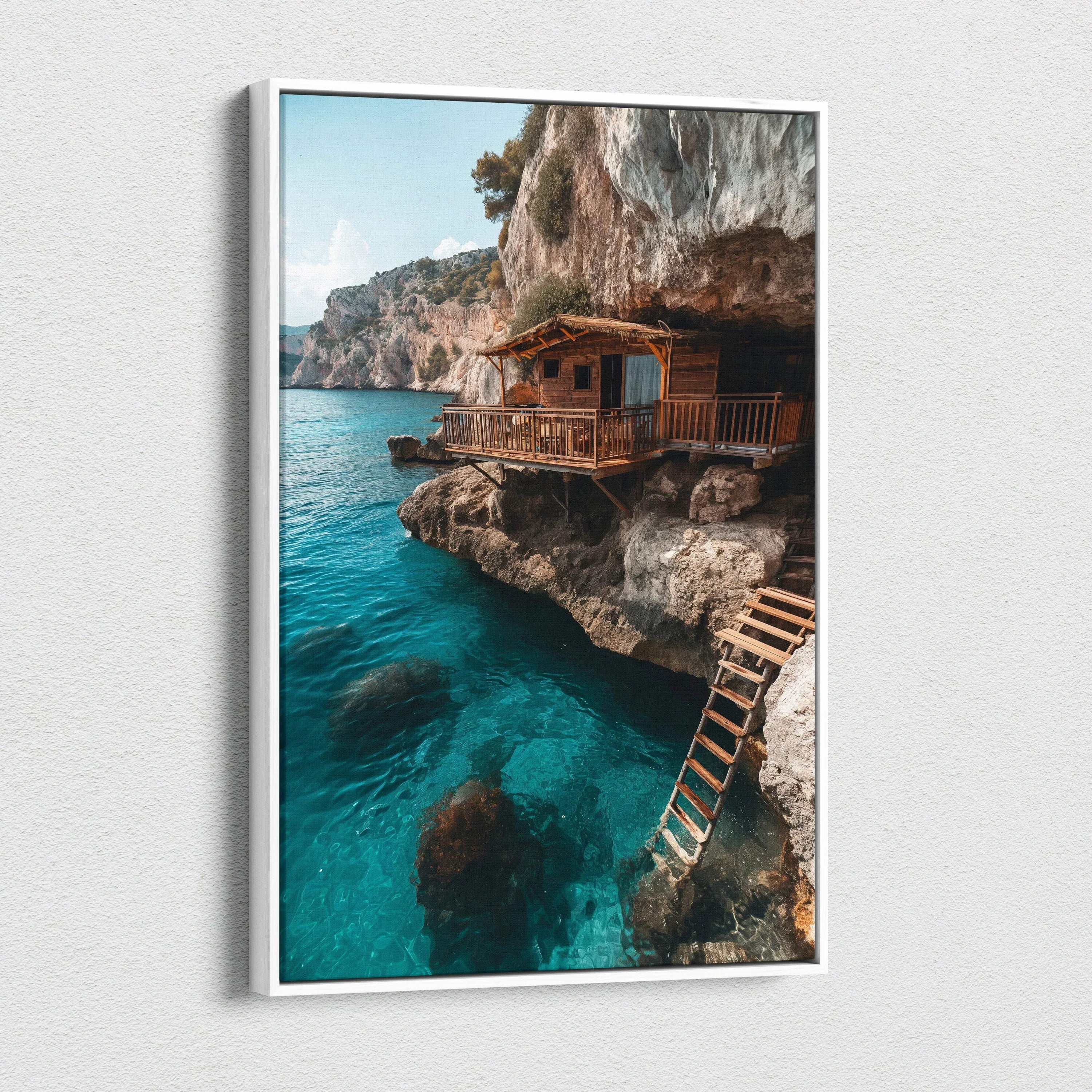 Vertical canvas art of rustic wooden house on rocky cliff above clear blue sea wall art for home decor.