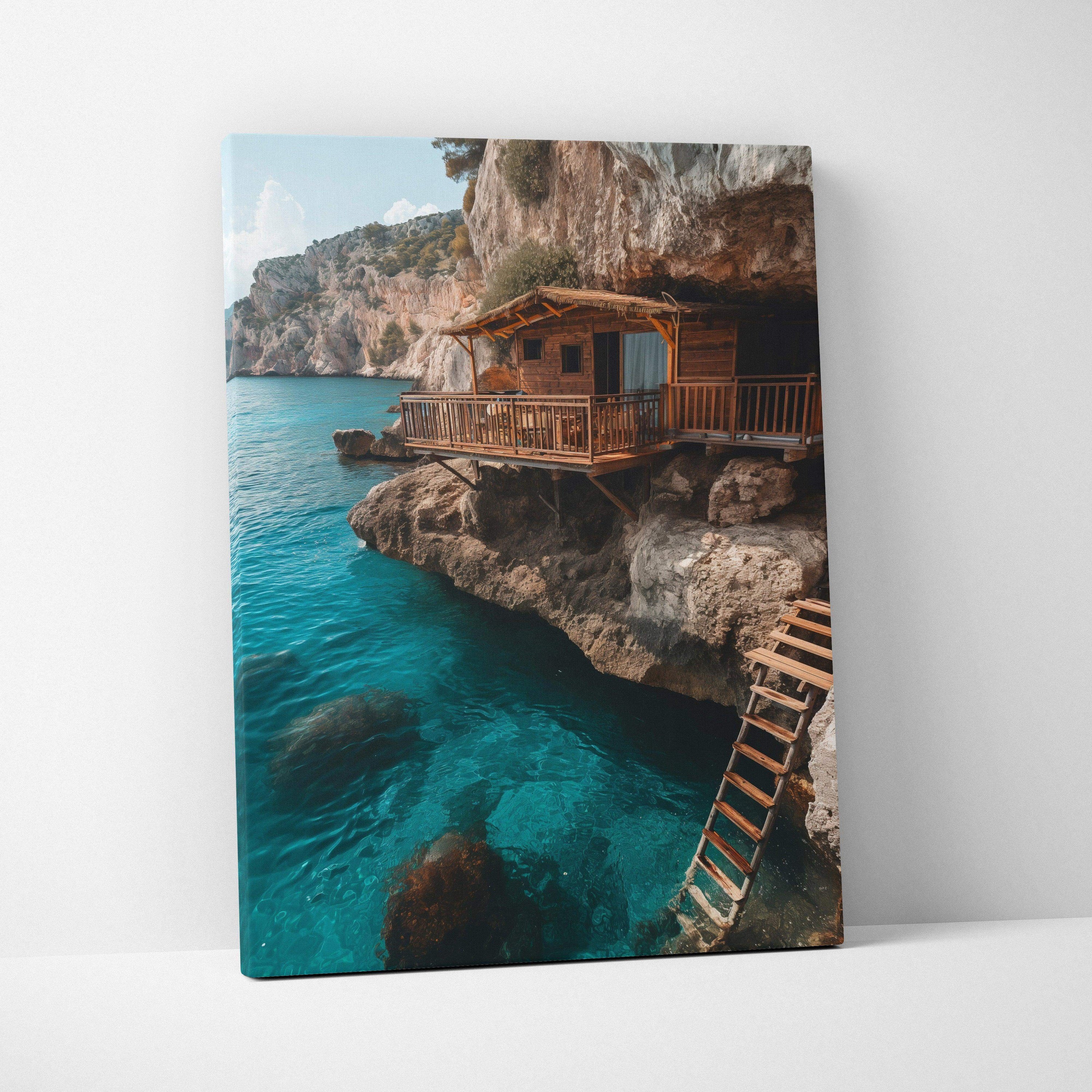 Canvas wall art featuring a rustic wooden cabin perched on rocky cliffs above clear blue water.