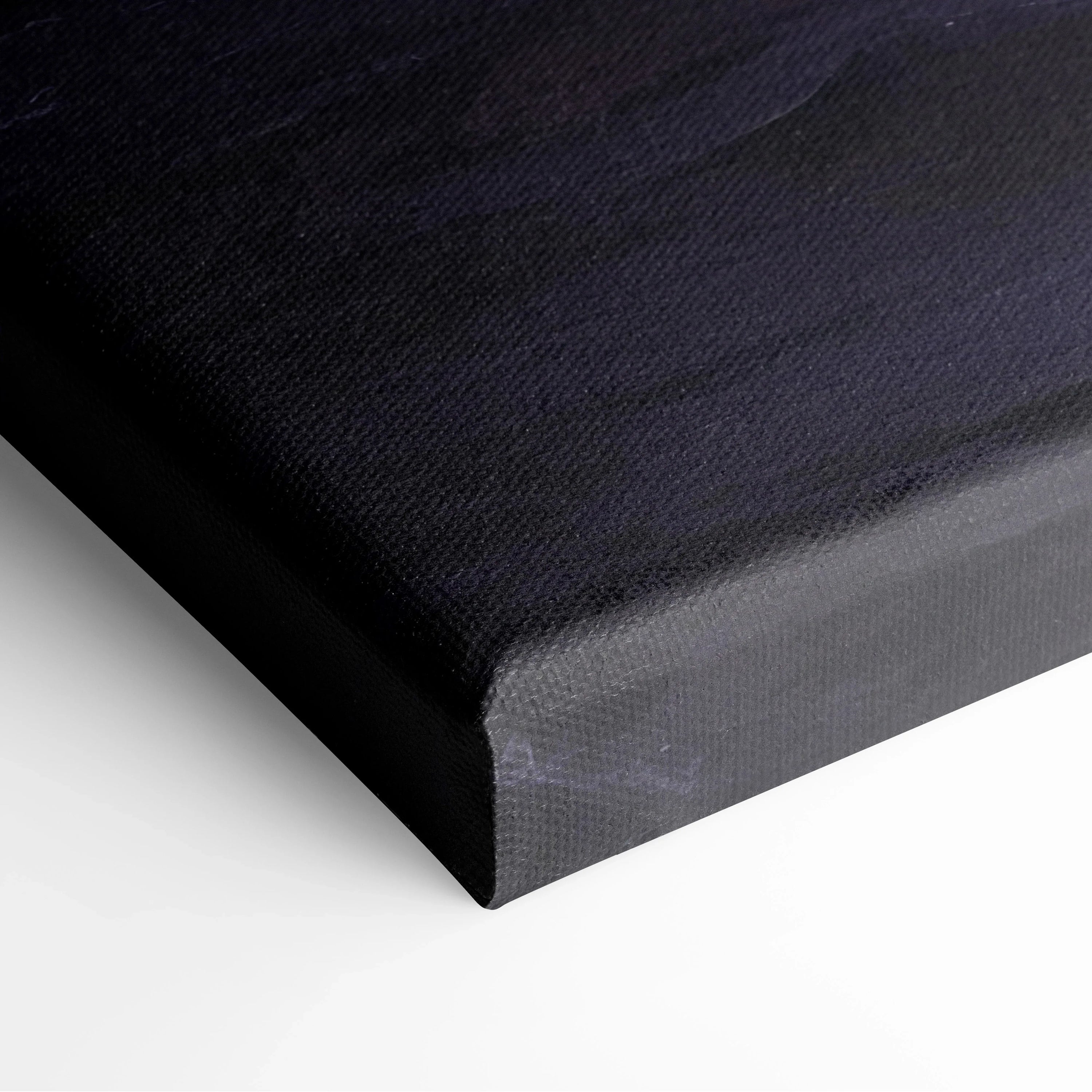 Close-up of black stretched canvas corner with tightly wrapped fabric on wooden frame for wall art decor.
