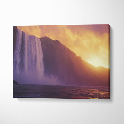 Sunset waterfall canvas wall art with golden sky and mountain silhouette decor.