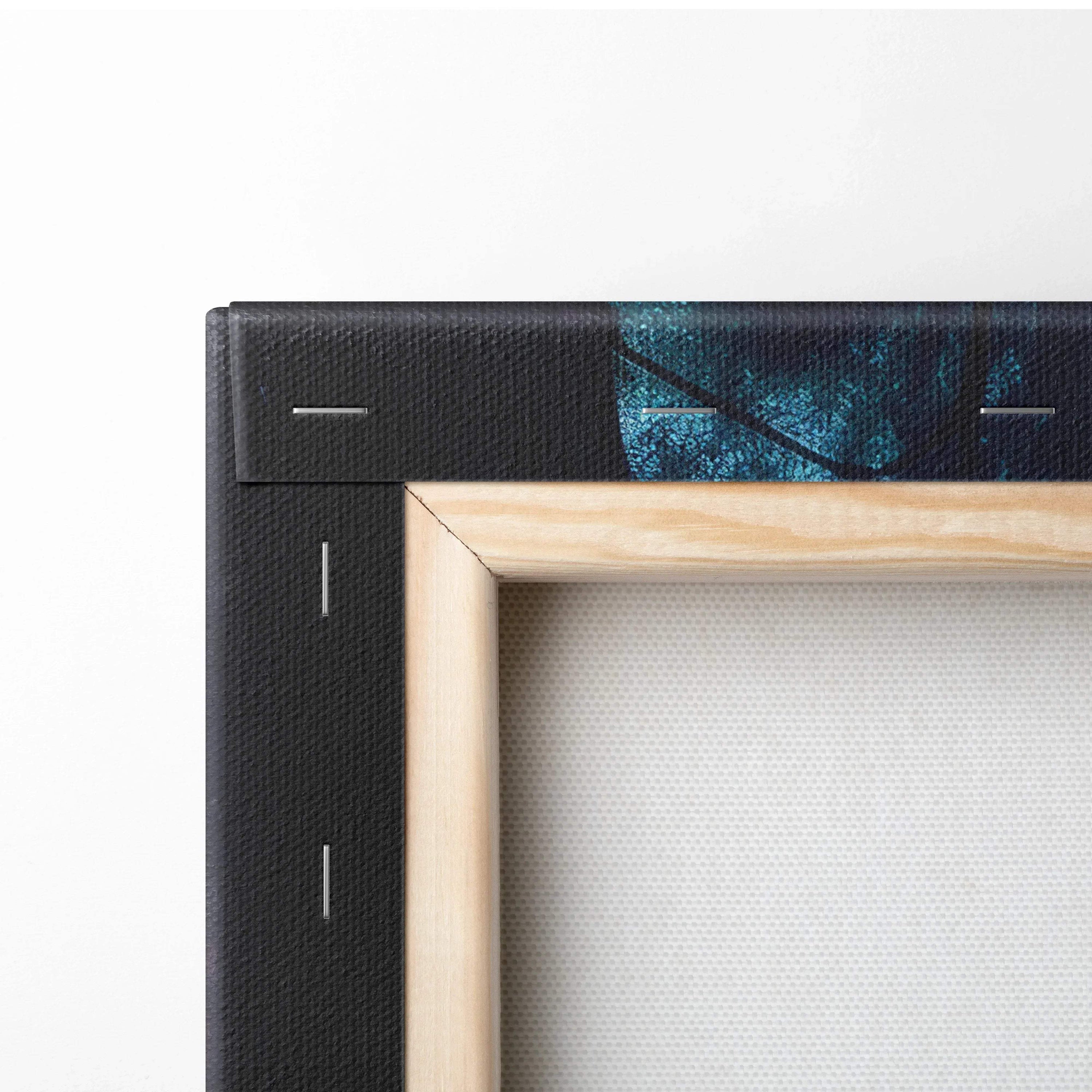 Close-up of wooden frame corner with black-stretched canvas, wall art decor detail.