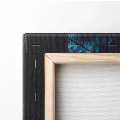 Close-up of wooden frame corner with black-stretched canvas, wall art decor detail.
