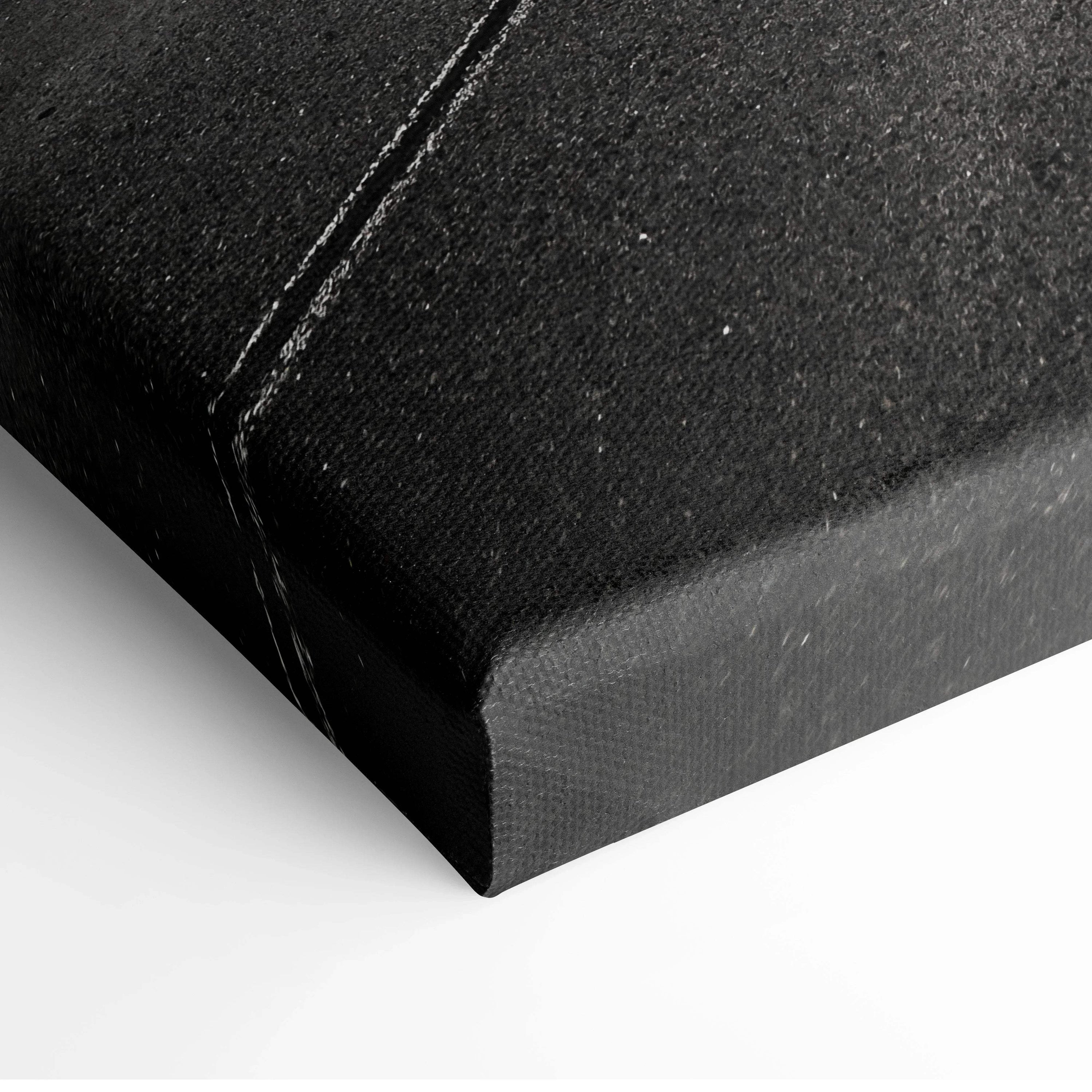 Black textured canvas corner with visible stitching, modern wall art decor detail.