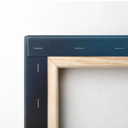 Close-up of a stretched canvas corner with light wooden frame and navy blue fabric backing for wall art decor.
