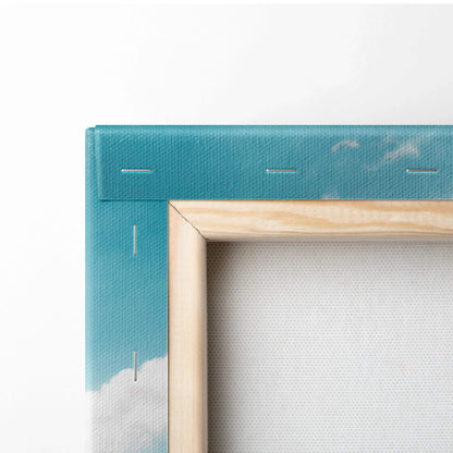 Close-up of wooden stretcher frame with sky-blue canvas and visible staples for wall art display.