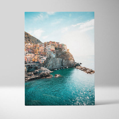 Manarola colorful cliffside buildings over turquoise sea canvas wall art with bright sky.