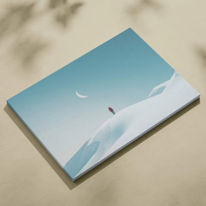 Canvas wall art featuring a man standing on a snowy hill under a glowing crescent moon in a clear blue sky.