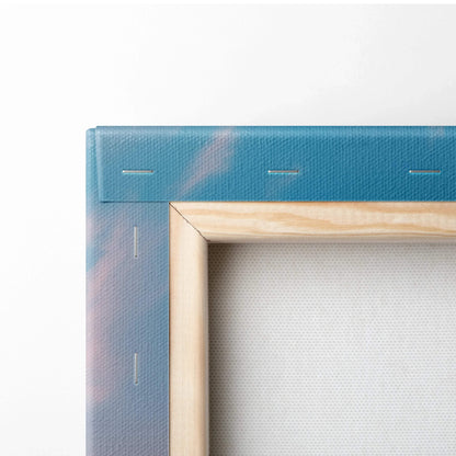 Close-up of stretched canvas art with natural wood frame and blue beach sunset print edges.