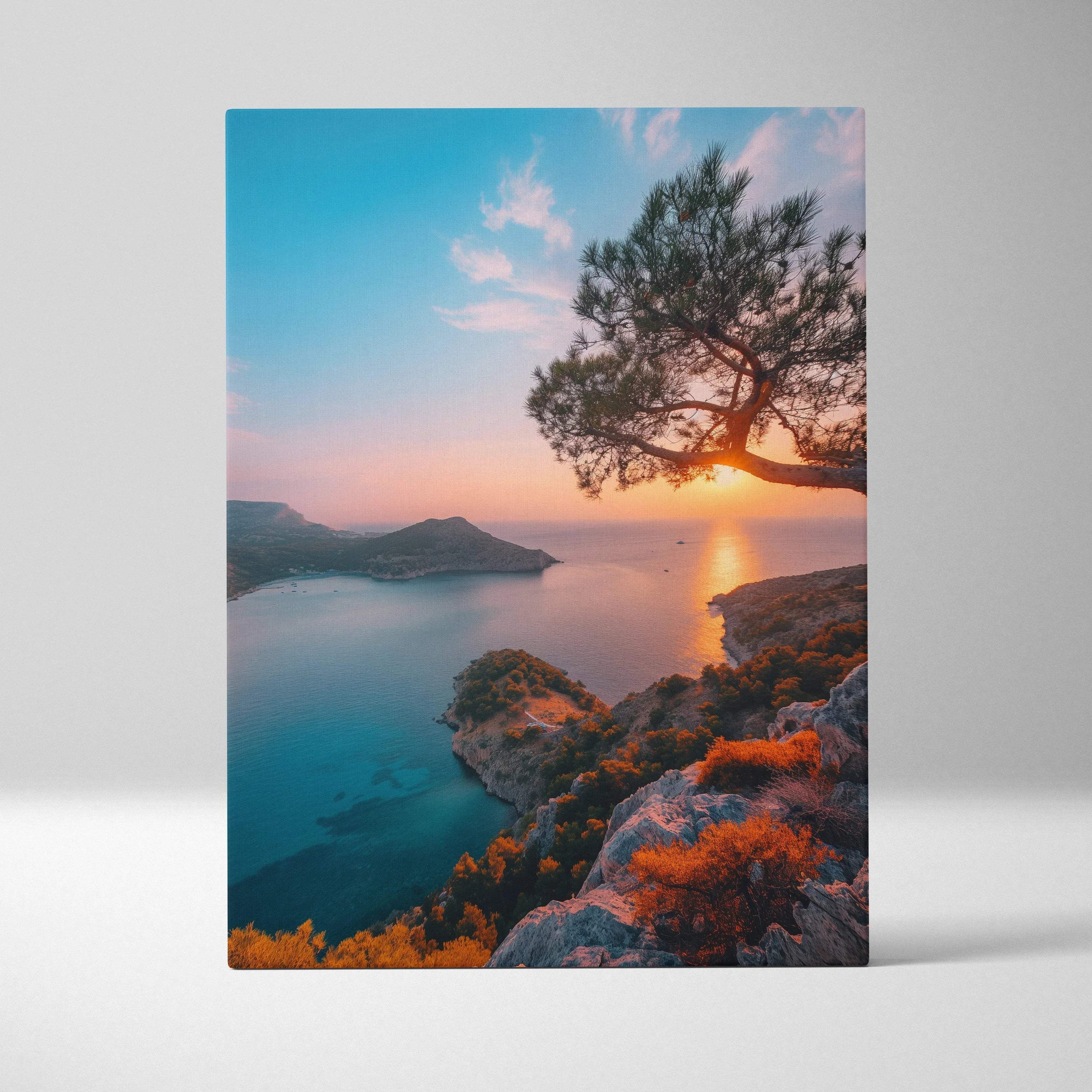 Canvas wall art featuring a vibrant beach sunset with blue skies, a silhouetted tree, and rocky coastline.