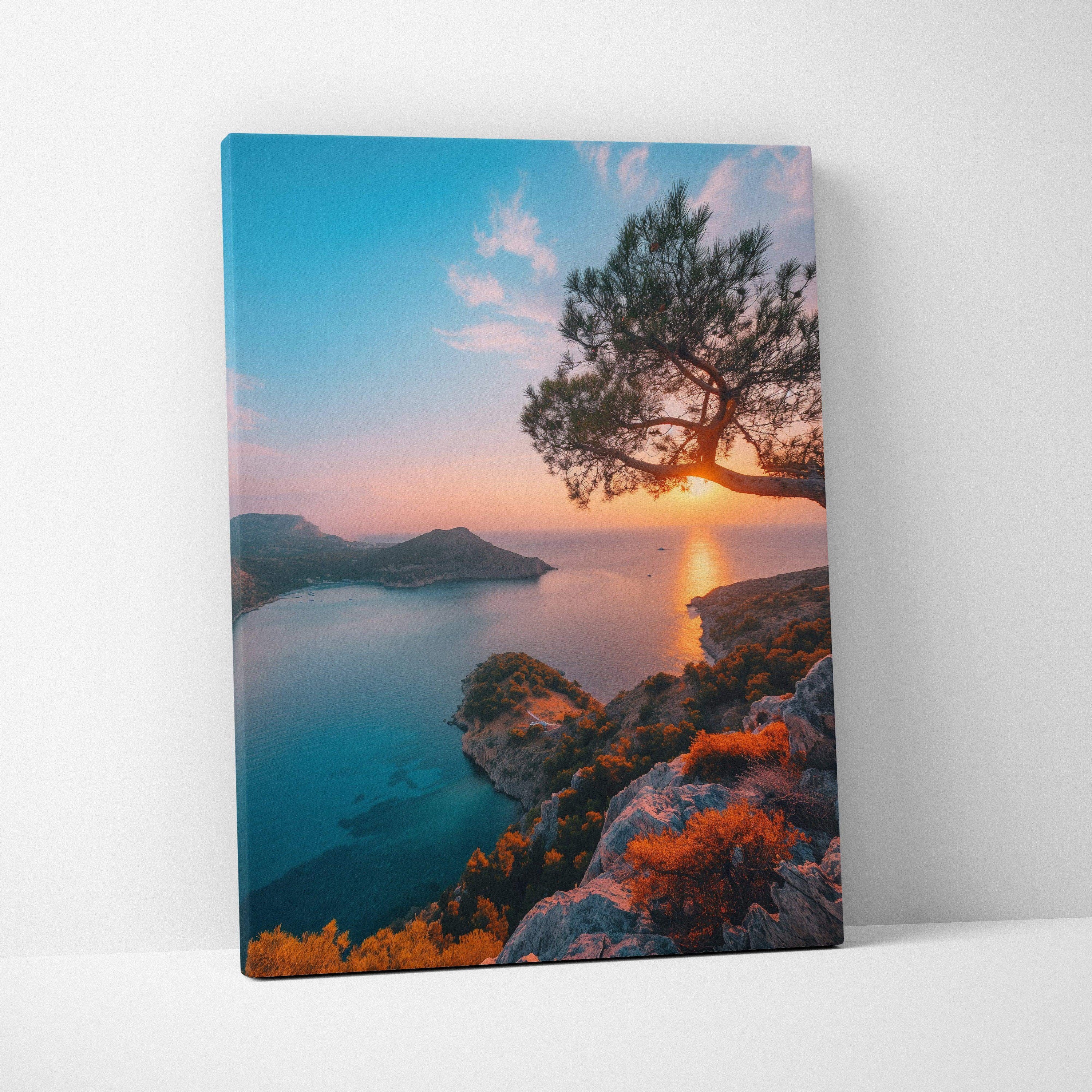 Canvas wall art featuring a vibrant sunset over a coastal beach with rocky cliffs and a silhouetted tree.