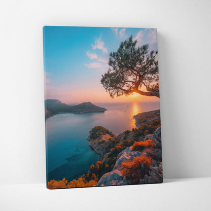 Canvas wall art featuring a vibrant sunset over a coastal beach with rocky cliffs and a silhouetted tree.
