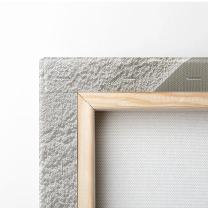 Close-up of wooden frame corner with textured white canvas and rough wall background for minimalist wall art decor.