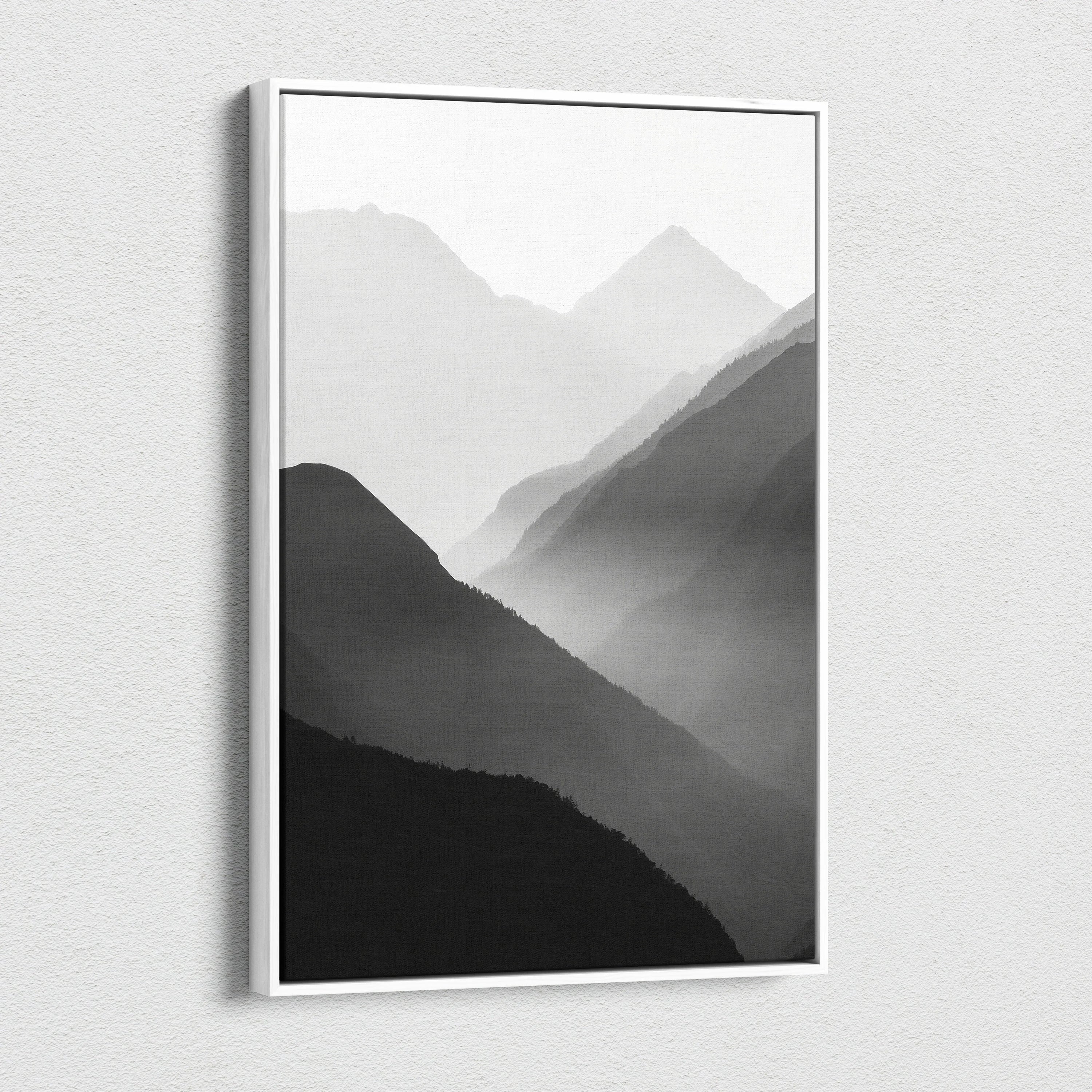 Minimalist digital art canvas print featuring layered black mountains in mist with soft gray gradients, framed wall art.