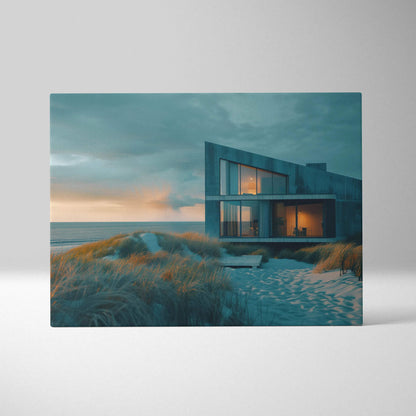 Modern architectural canvas wall art showing a sleek, angular building by the beach at sunset with soft blue and orange.