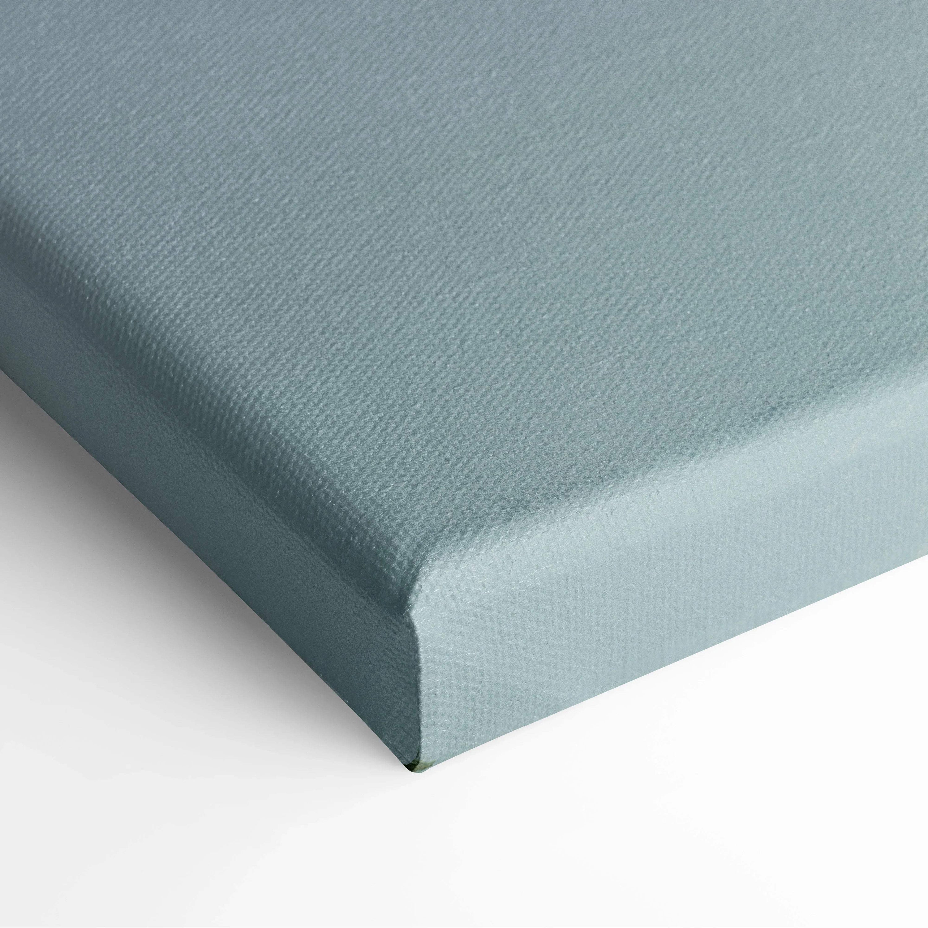 Soft blue stretched canvas corner with subtle fabric texture and sharp edges.