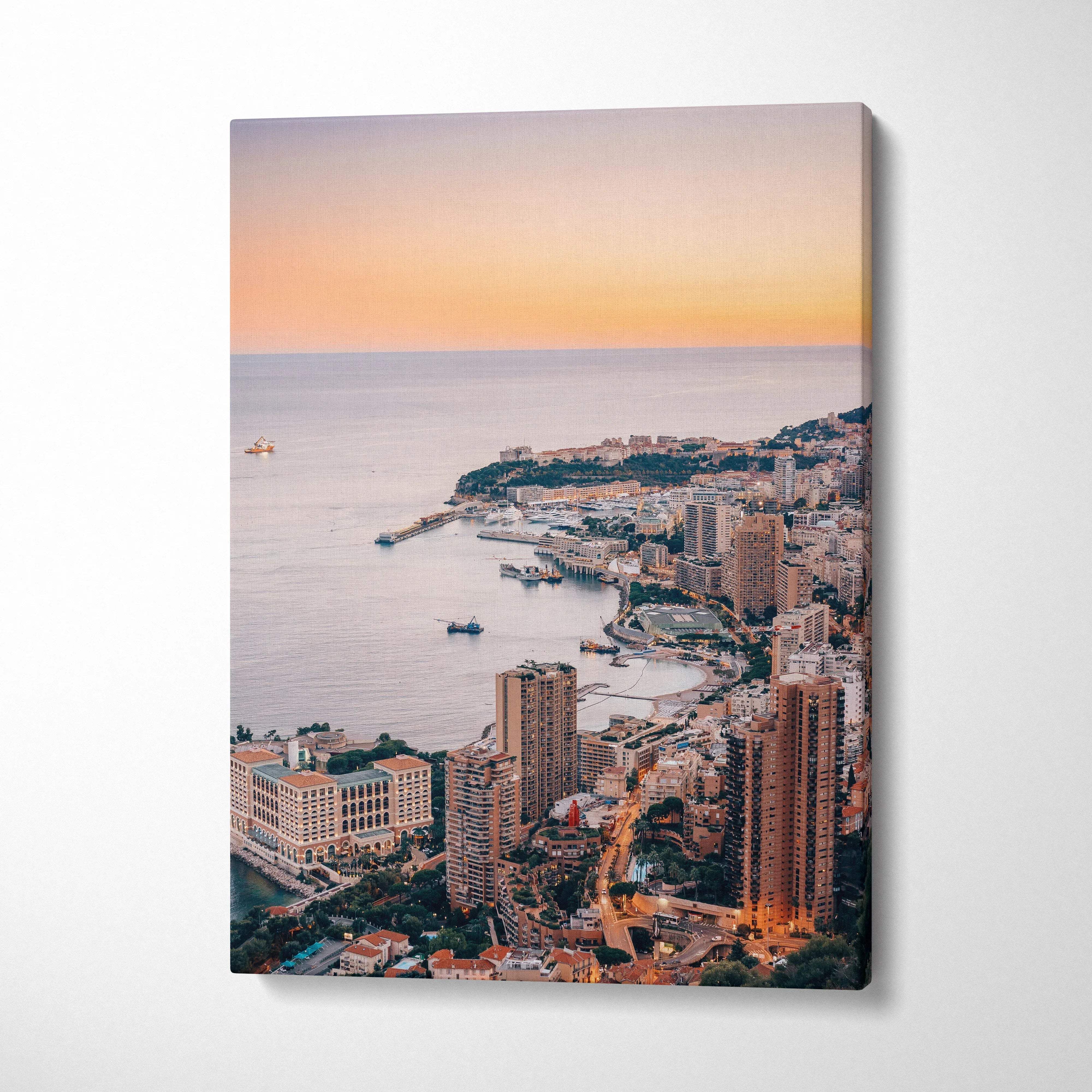 Vertical canvas wall art featuring Monaco cityscape at sunset with buildings along the coastline.