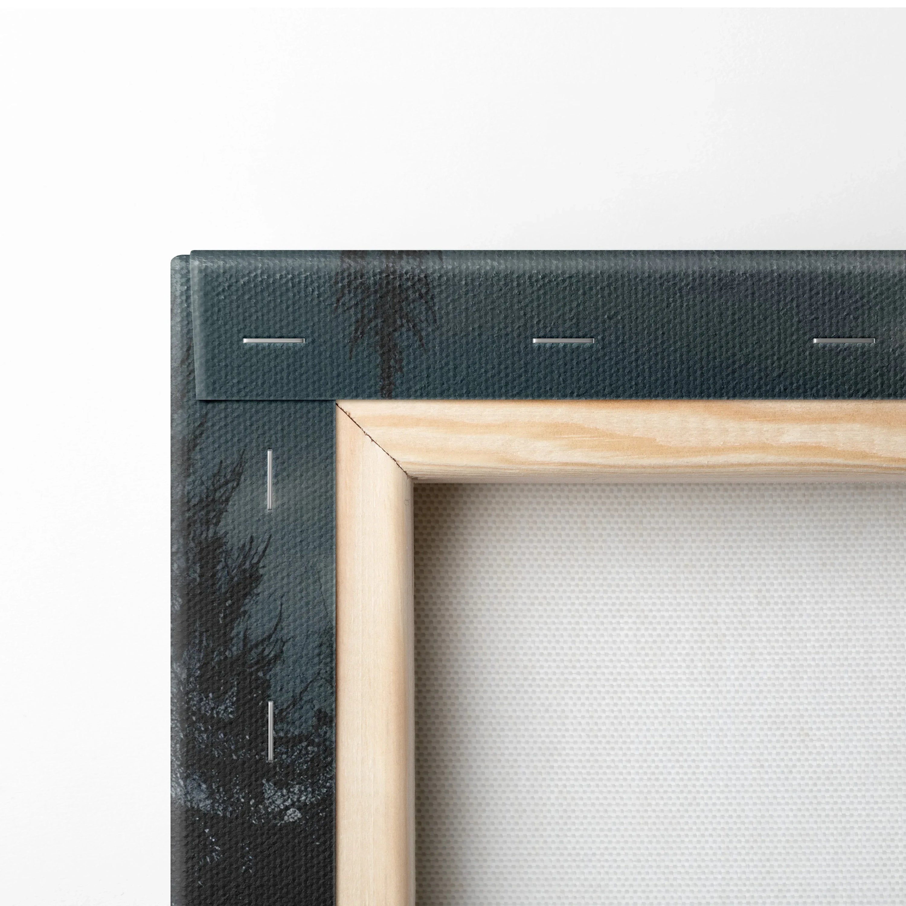 Close-up of canvas edge with wooden stretcher bar and folded forest landscape wall art decor.