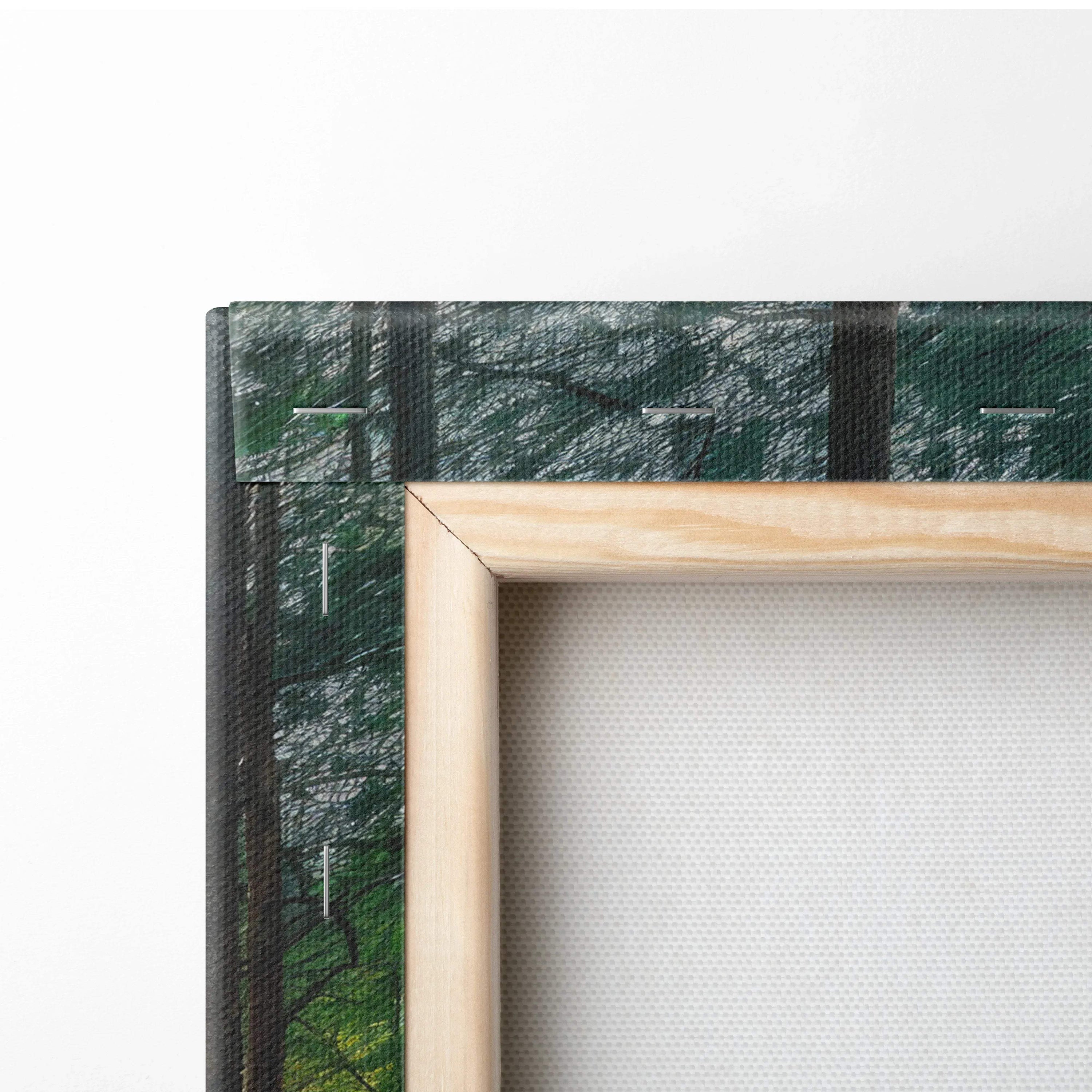 Close-up of canvas corner with wooden frame, showing textured forest-themed wall art decor.