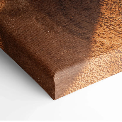Close-up of textured canvas art with warm, sandy brown and dark earth tones wrapped around wooden stretcher bars.