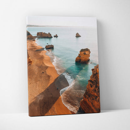 Canvas wall art depicting a serene beach scene with sandy cliffs and turquoise waves.