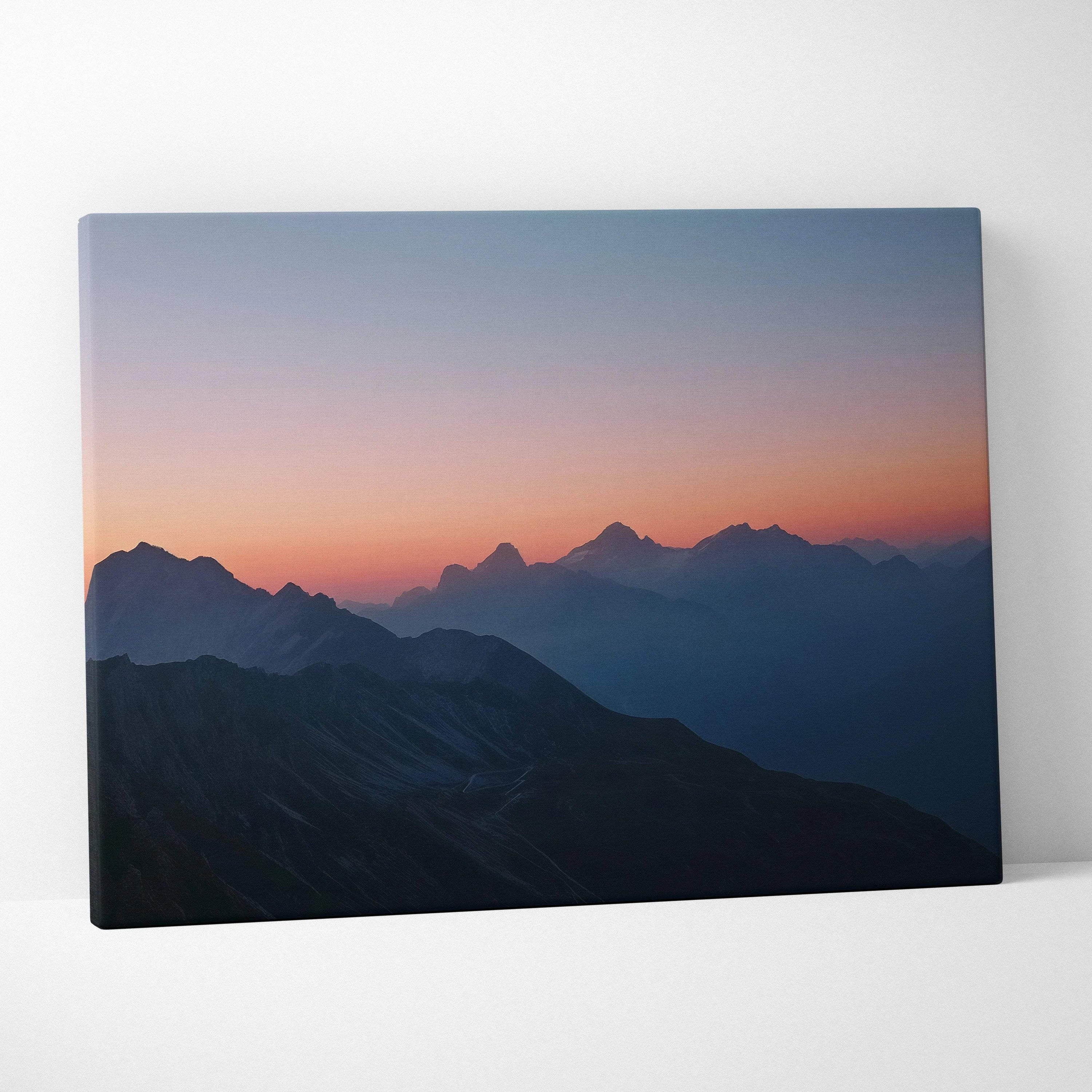 Canvas print of serene mountain range at dusk in lilac, coral, blue hues