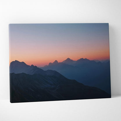 Canvas print of serene mountain range at dusk in lilac, coral, blue hues
