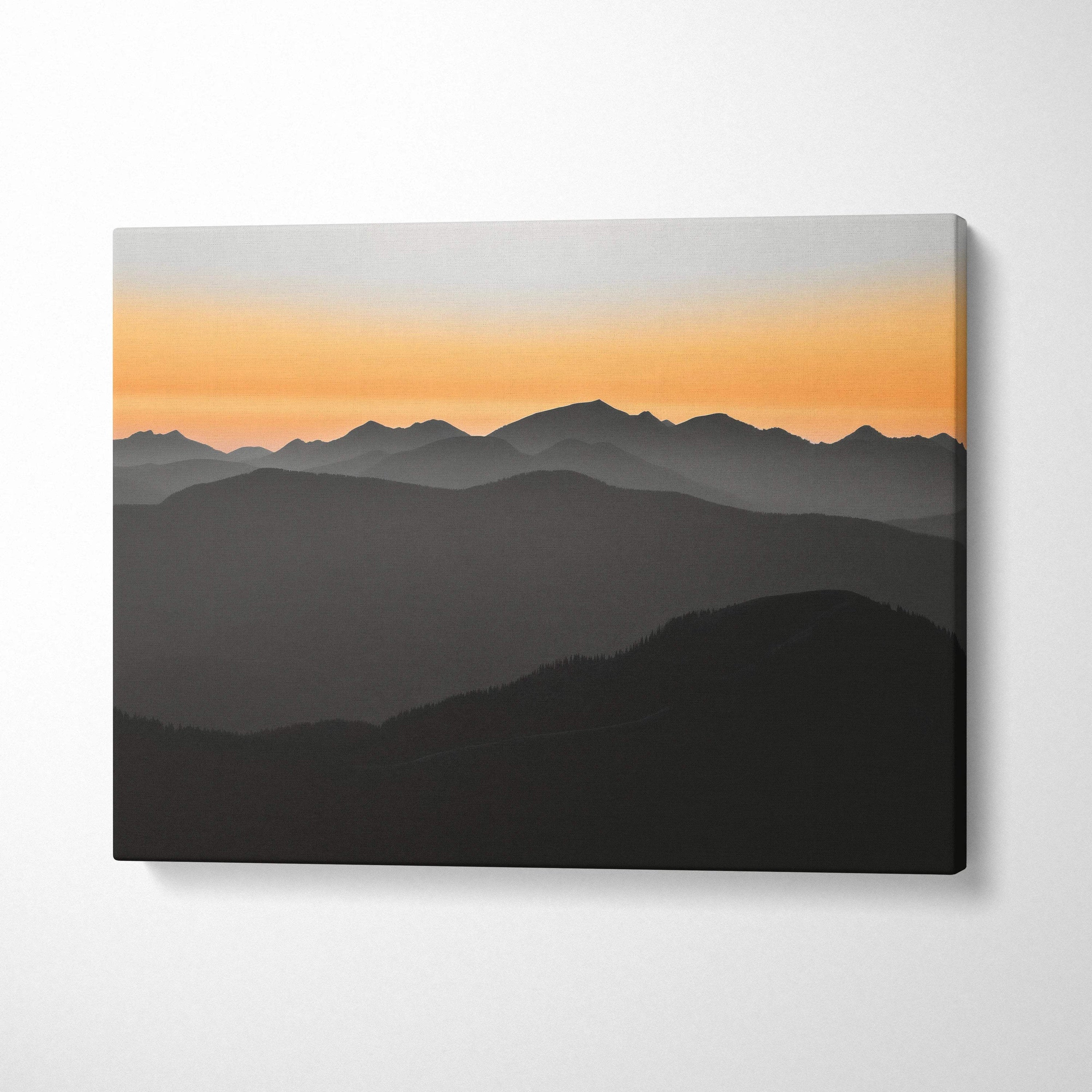 Minimalist layered mountain canvas wall art with orange to gray sunset gradient sky
