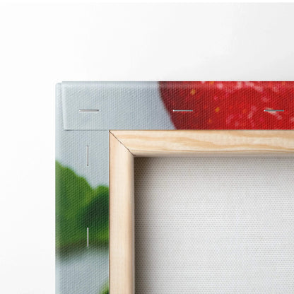 Close-up of wooden framed canvas wall art with vibrant red, green, and white colors from fruit bowl design.