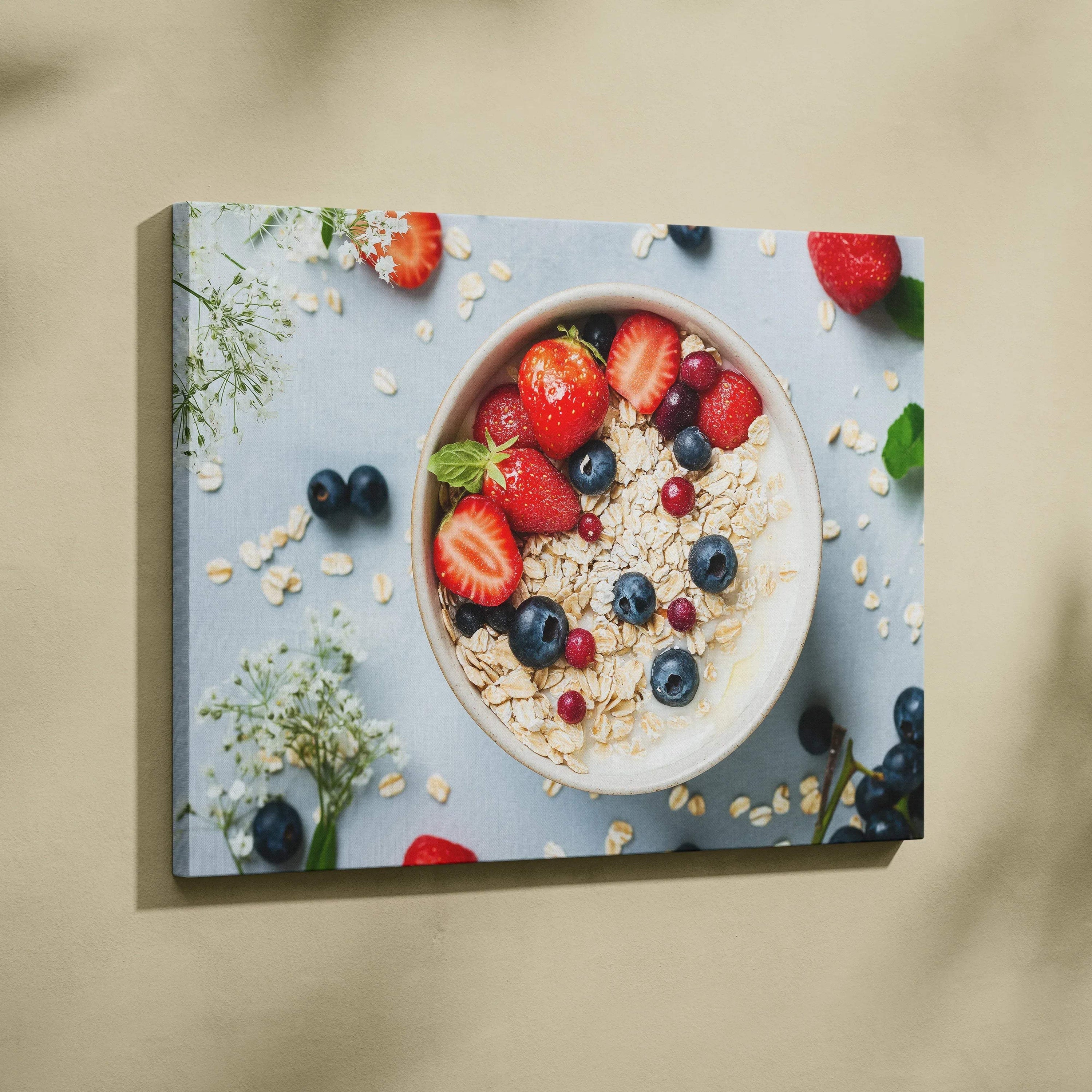 Canvas wall art featuring a breakfast bowl with granola, strawberries, blueberries, and cream on a beige background.
