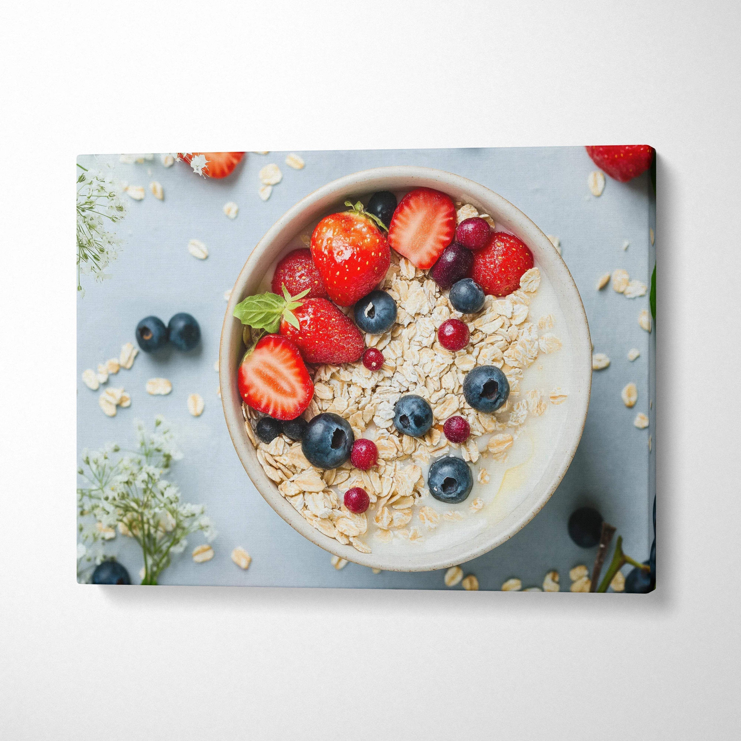 Canvas wall art featuring a breakfast bowl with granola, strawberries, blueberries, and red currants on blue background.