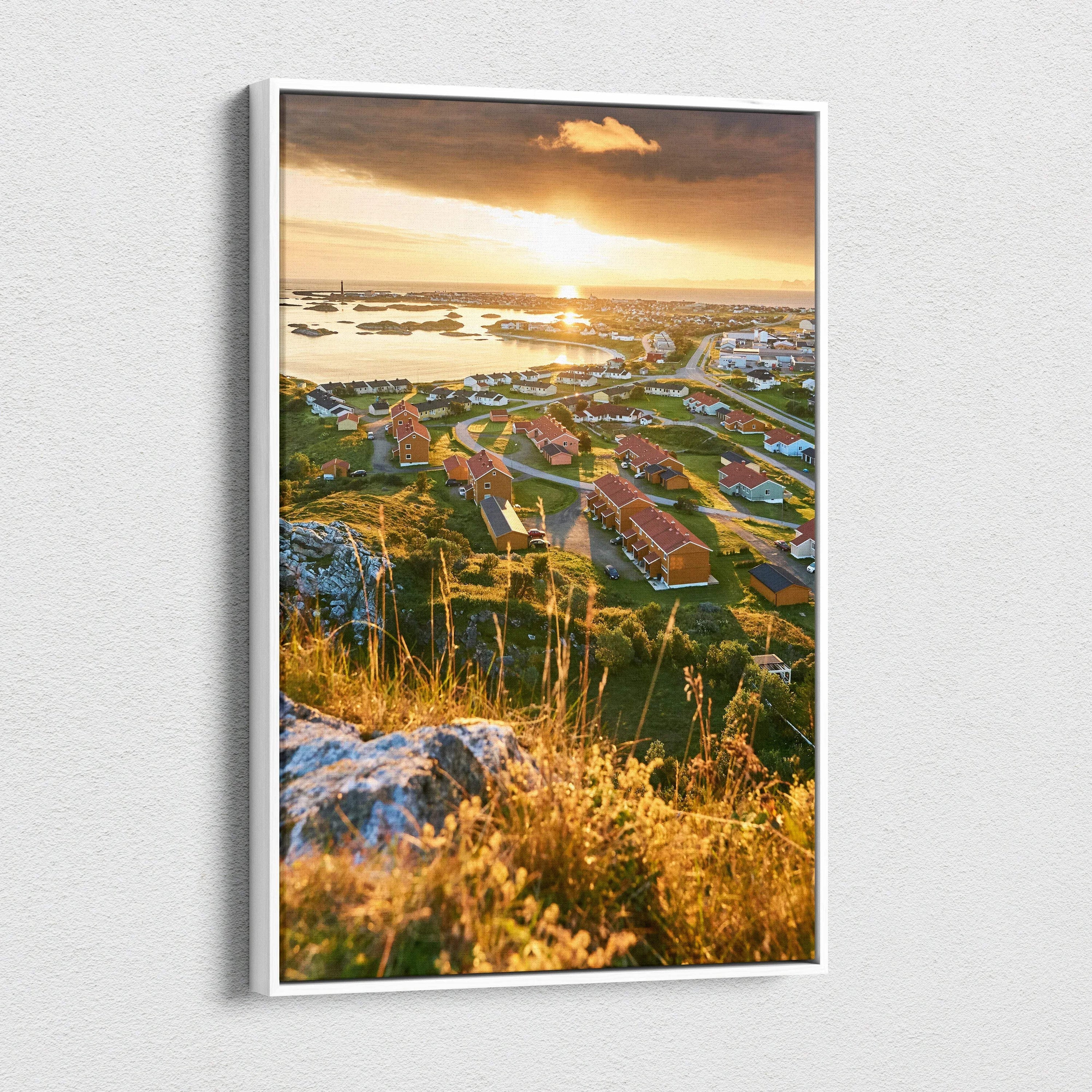 High-resolution canvas art featuring sunlit Norwegian town with red-roofed buildings and rocky landscape at sunset.