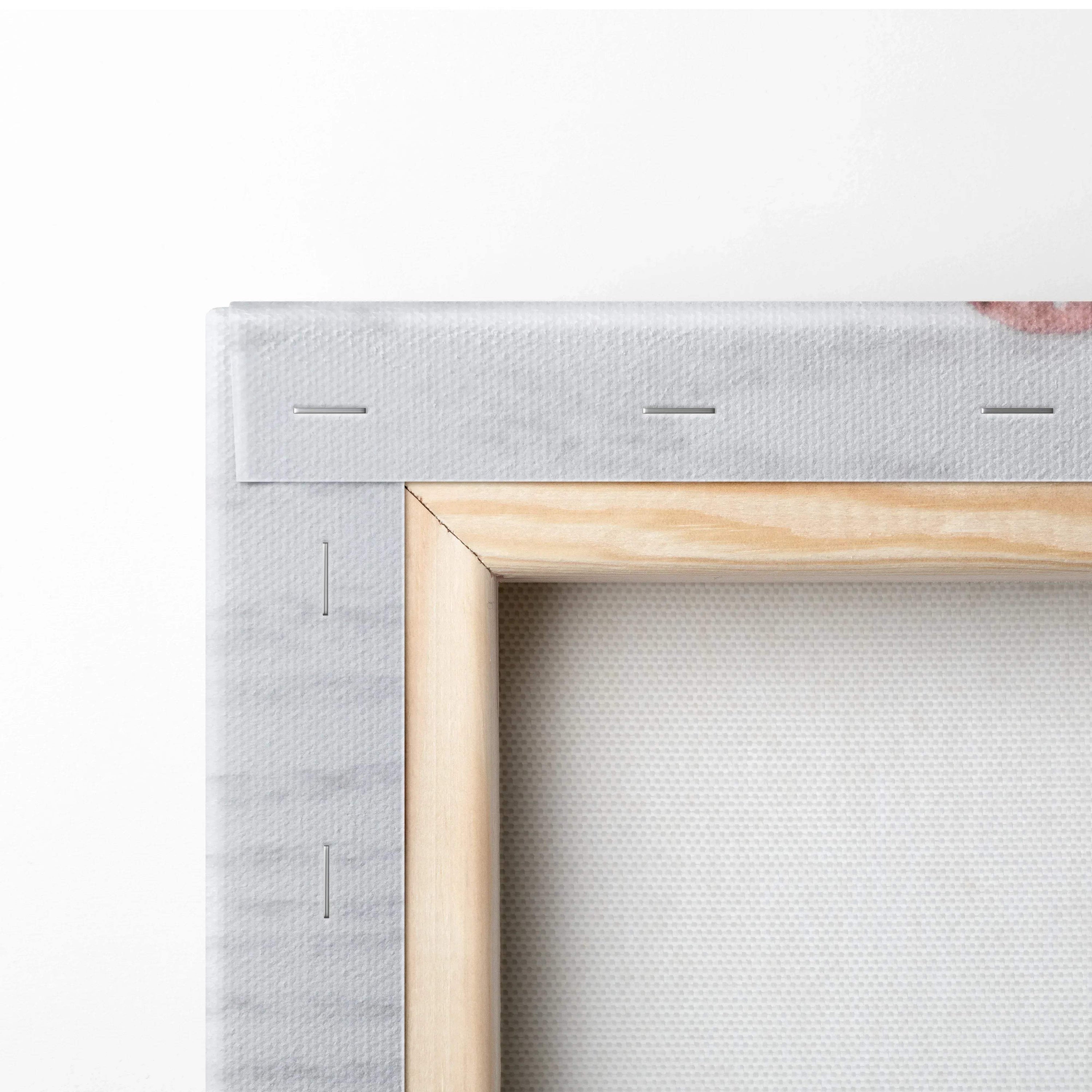 Close-up of wooden frame and white canvas texture with visible staples on the back of wall art.