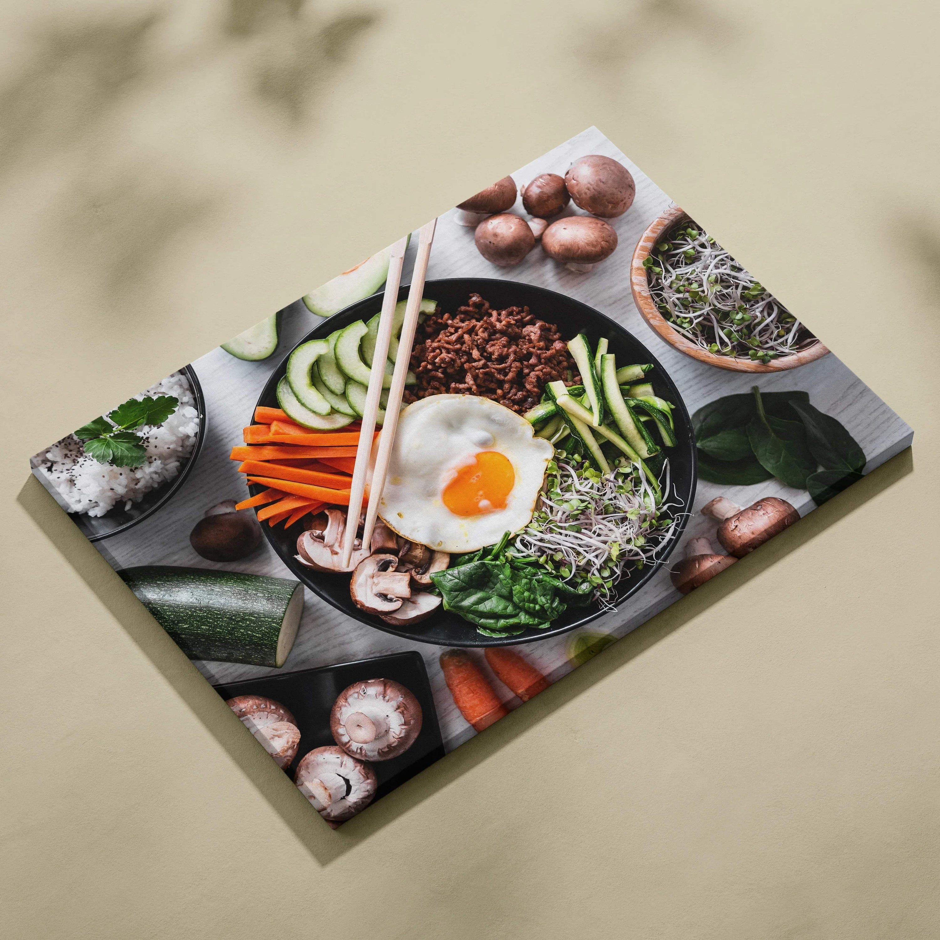 Colorful canvas wall art featuring a fresh bowl of food with vegetables and an egg, ideal for kitchen decor.