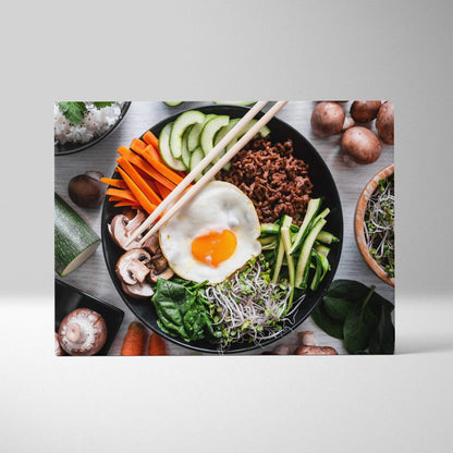 Colorful canvas wall art of a fresh bowl with egg, vegetables, and greens for kitchen decor.