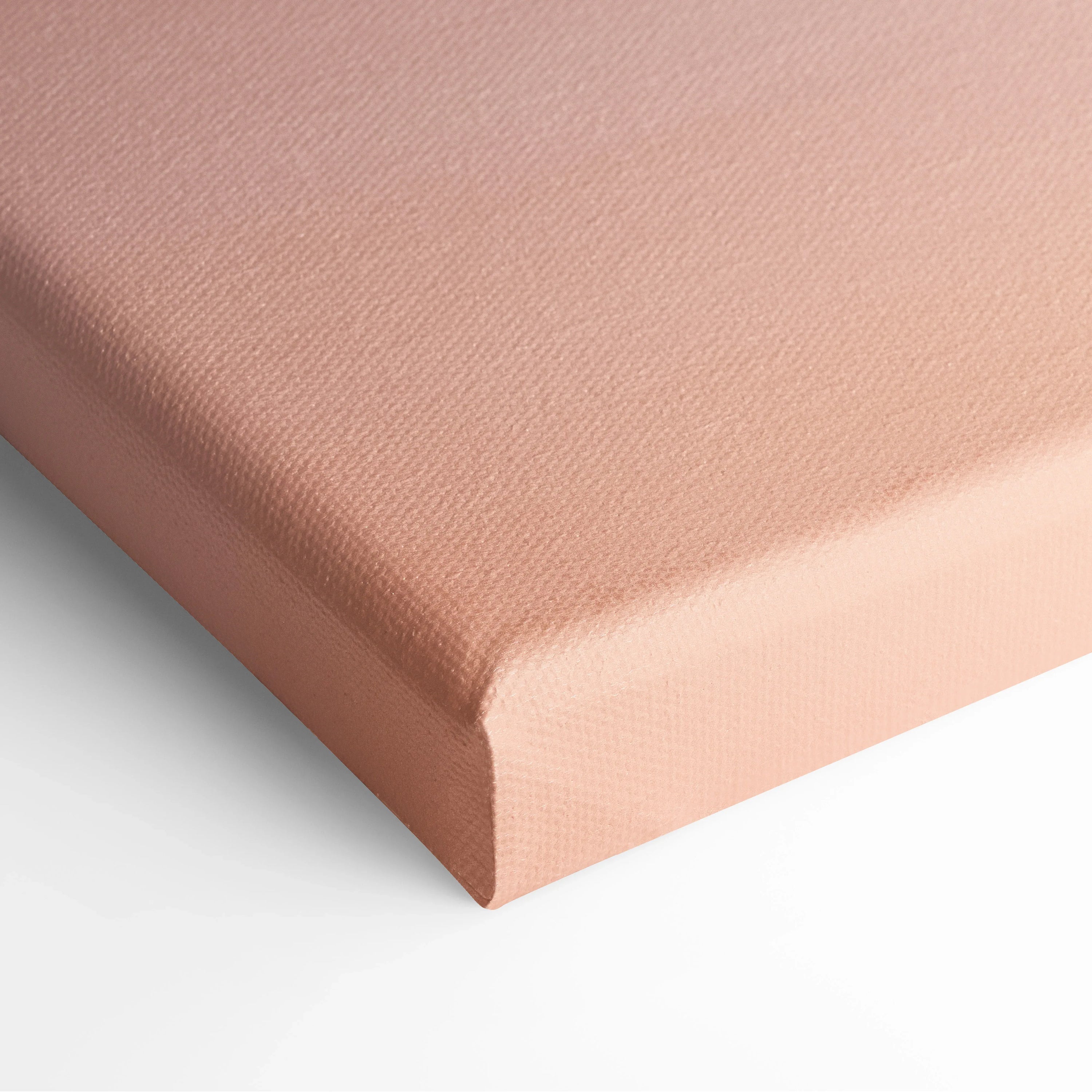 Close-up of peach-colored canvas corner showcasing texture and stretched edges for wall art decor.