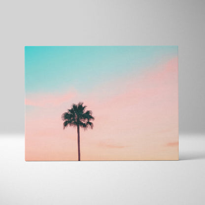 Minimalist canvas wall art featuring a black palm tree silhouette against a pastel sunset sky for modern decor.