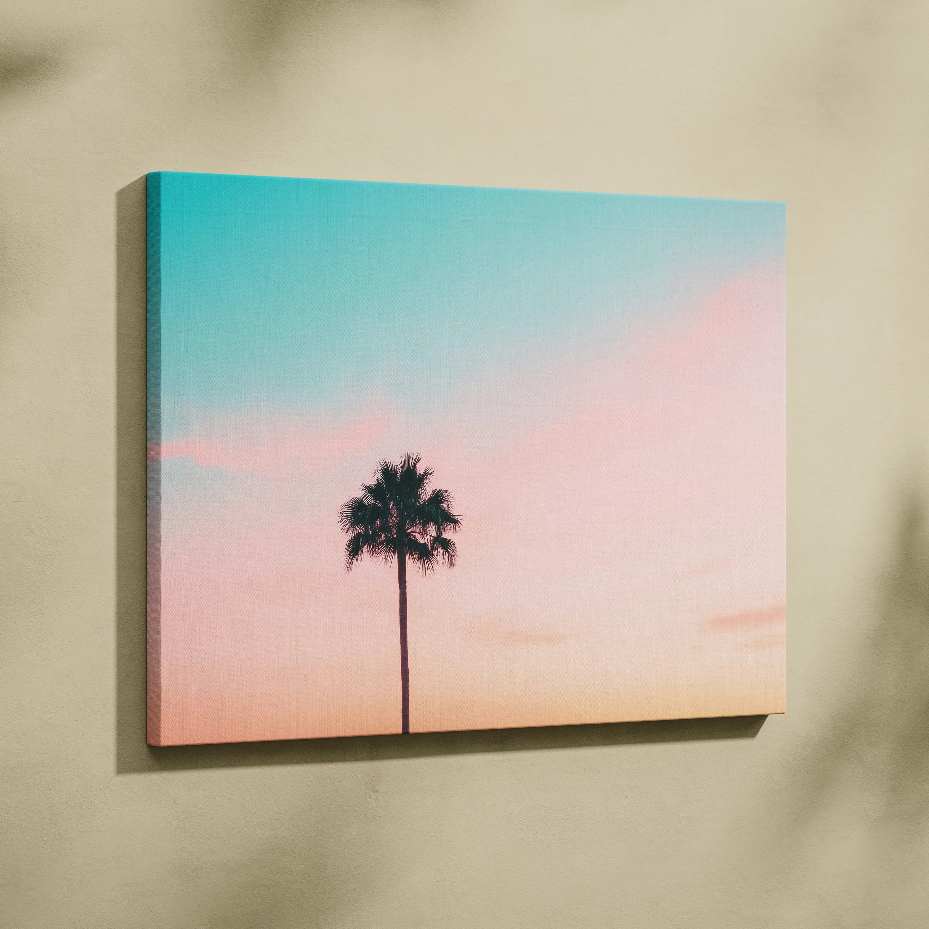 Canvas wall art featuring a minimalist palm tree silhouette at sunset with pastel pink and blue sky decor.