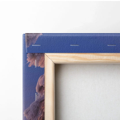 Close-up of wooden frame and blue fabric wrapped canvas corner with visible staples on backside of wall art.