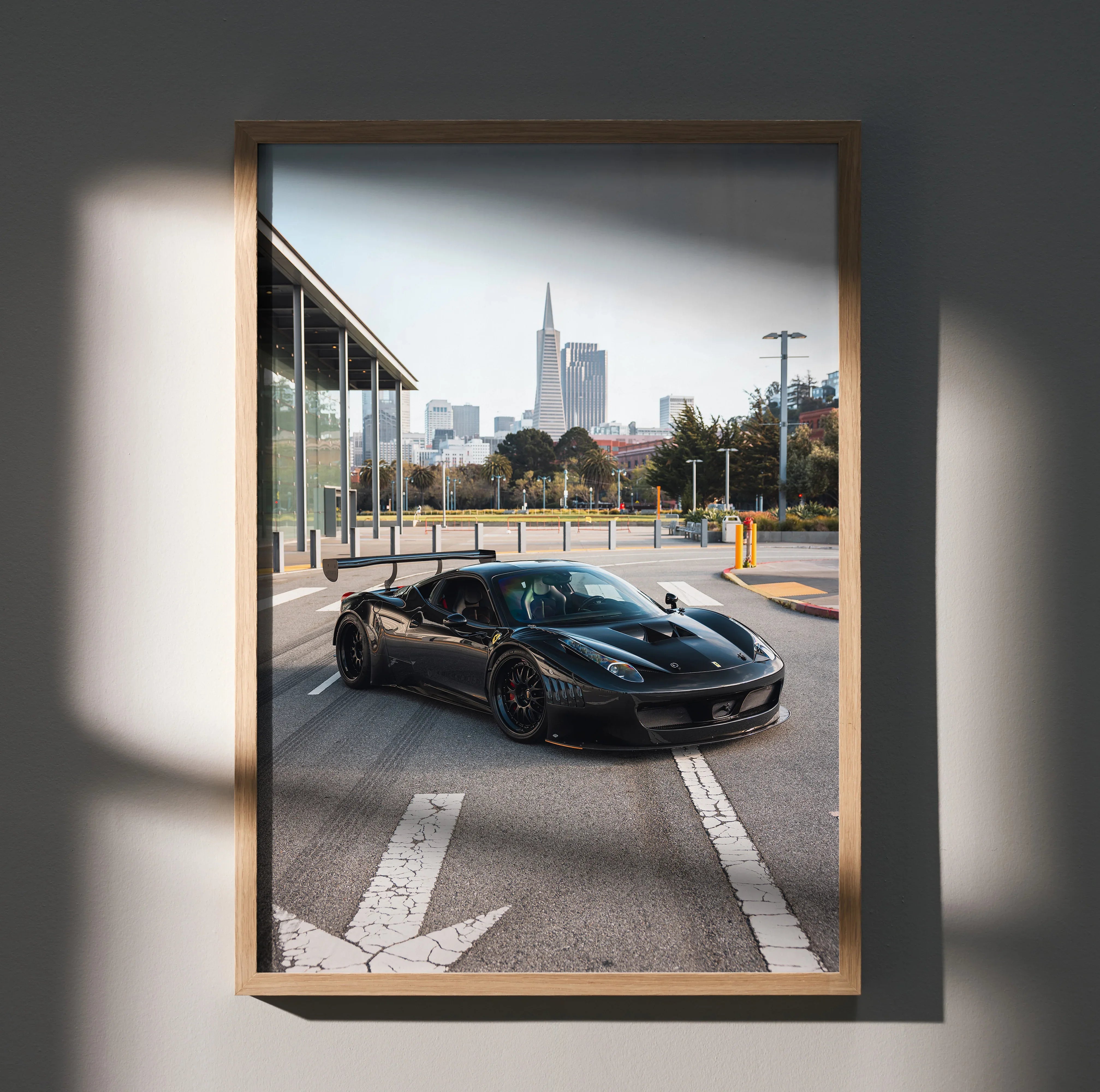 Ferrari 458 Italia GT3 black race car on city street poster wall art in wooden frame.