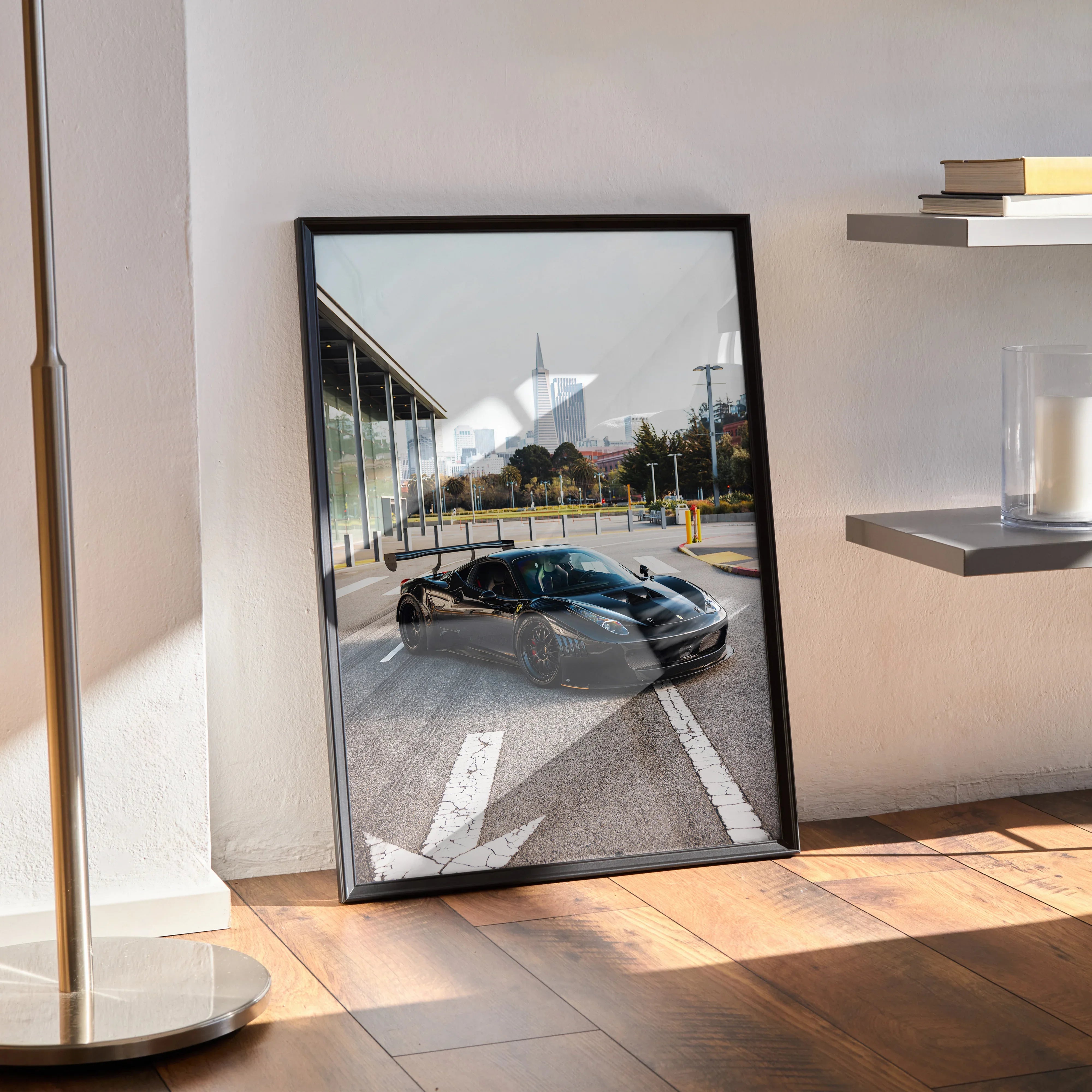 Ferrari 458 Italia GT3 poster leaning against wall, modern room with sunlight and shelves, sleek black sports car wall art.