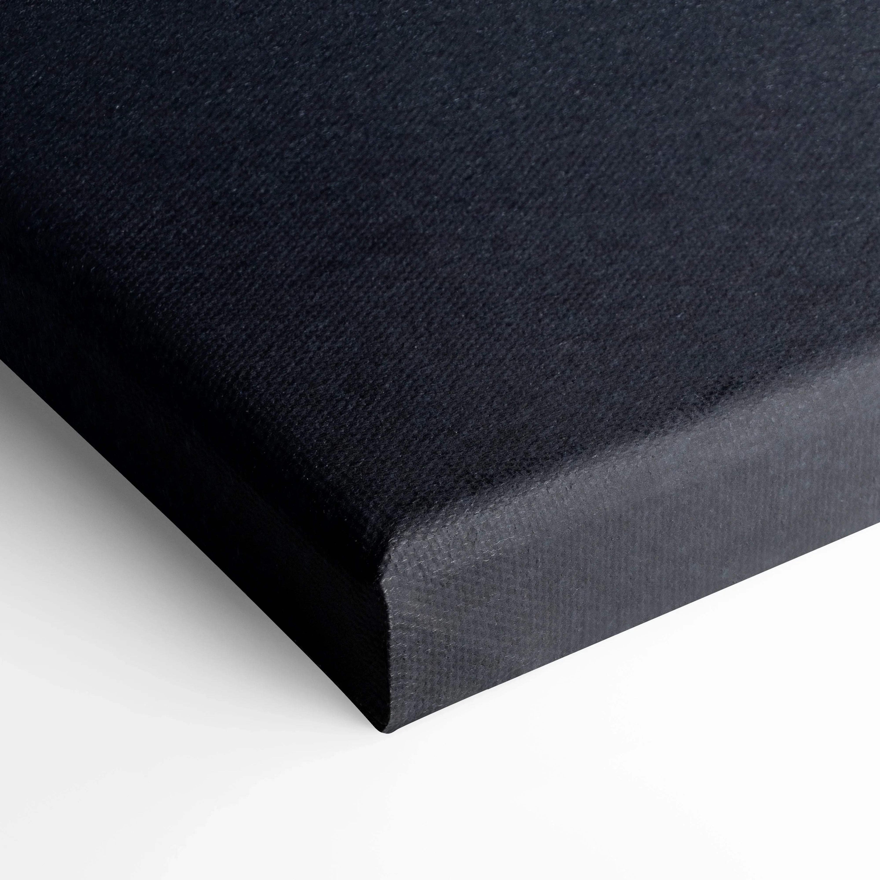 Close-up of black stretched canvas corner showcasing texture and clean edges for wall art.