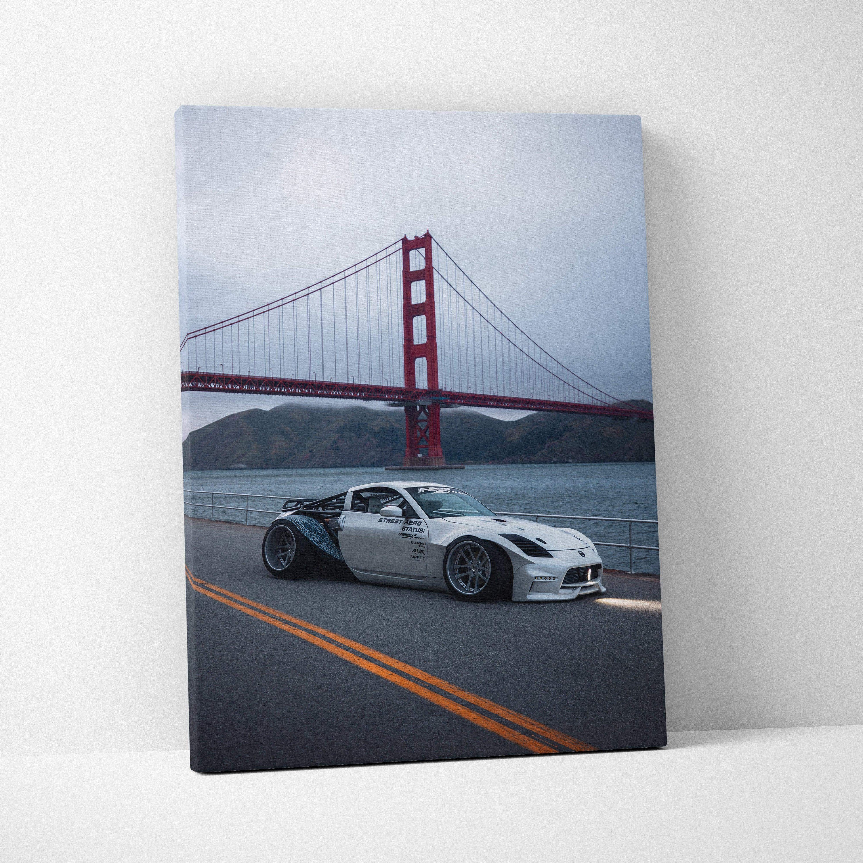 Nissan 350z driving on road near Golden Gate Bridge canvas wall art with moody sky.