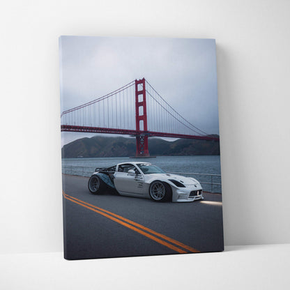 Nissan 350z driving on road near Golden Gate Bridge canvas wall art with moody sky.