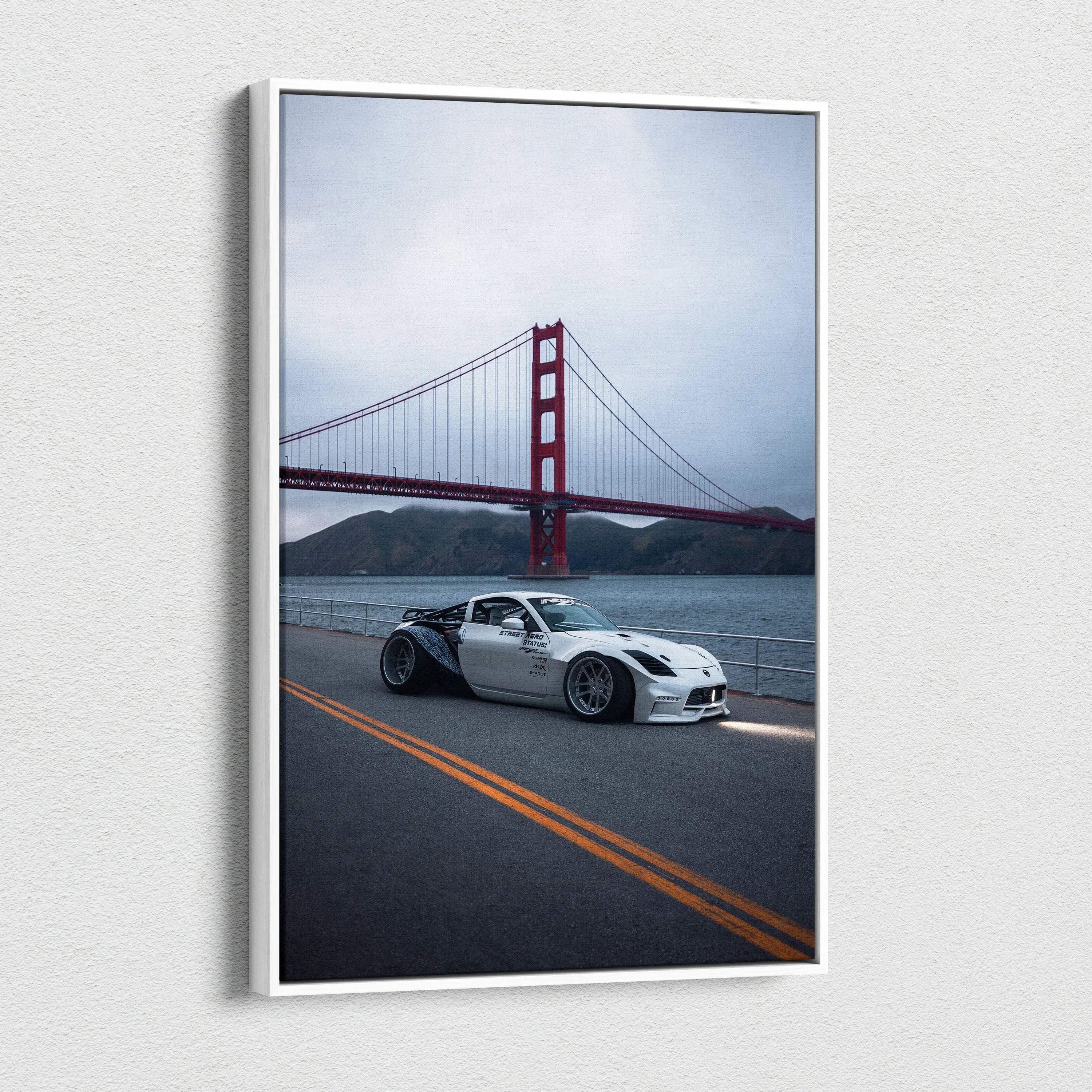Vertical canvas art featuring a white Nissan 350z on a road with the Golden Gate Bridge in the background.