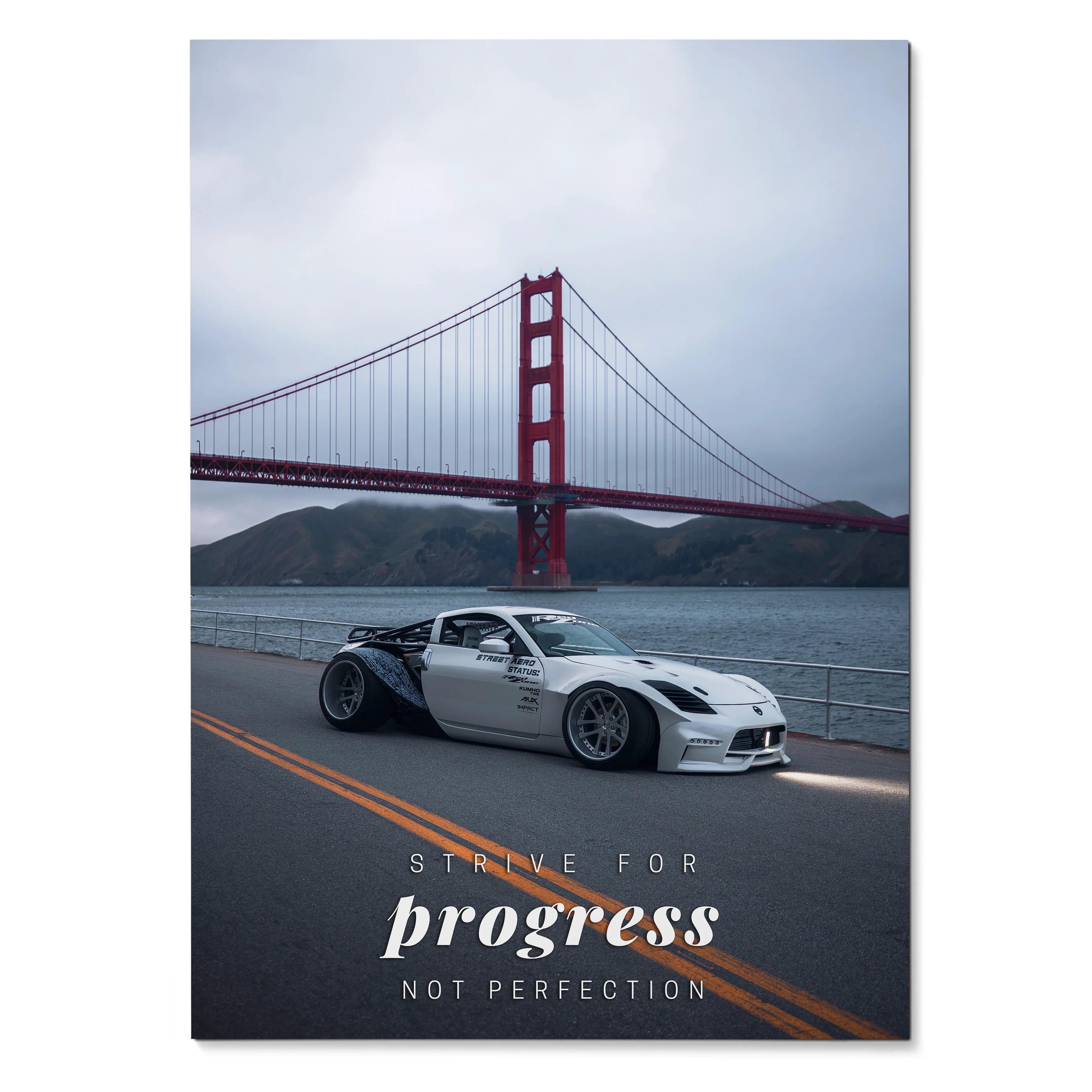 Motivational poster wall art featuring a white Nissan 350z on a road with the Golden Gate Bridge in the background and.