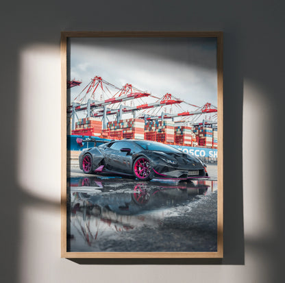 Lamborghini Huracan poster with red-accented wheels parked near port cranes, wall art in wooden frame.